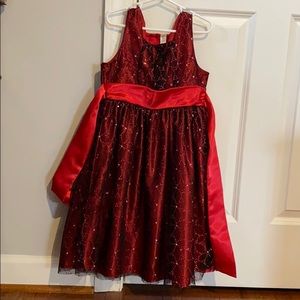 A sparkly red dress with a flower pattern.
